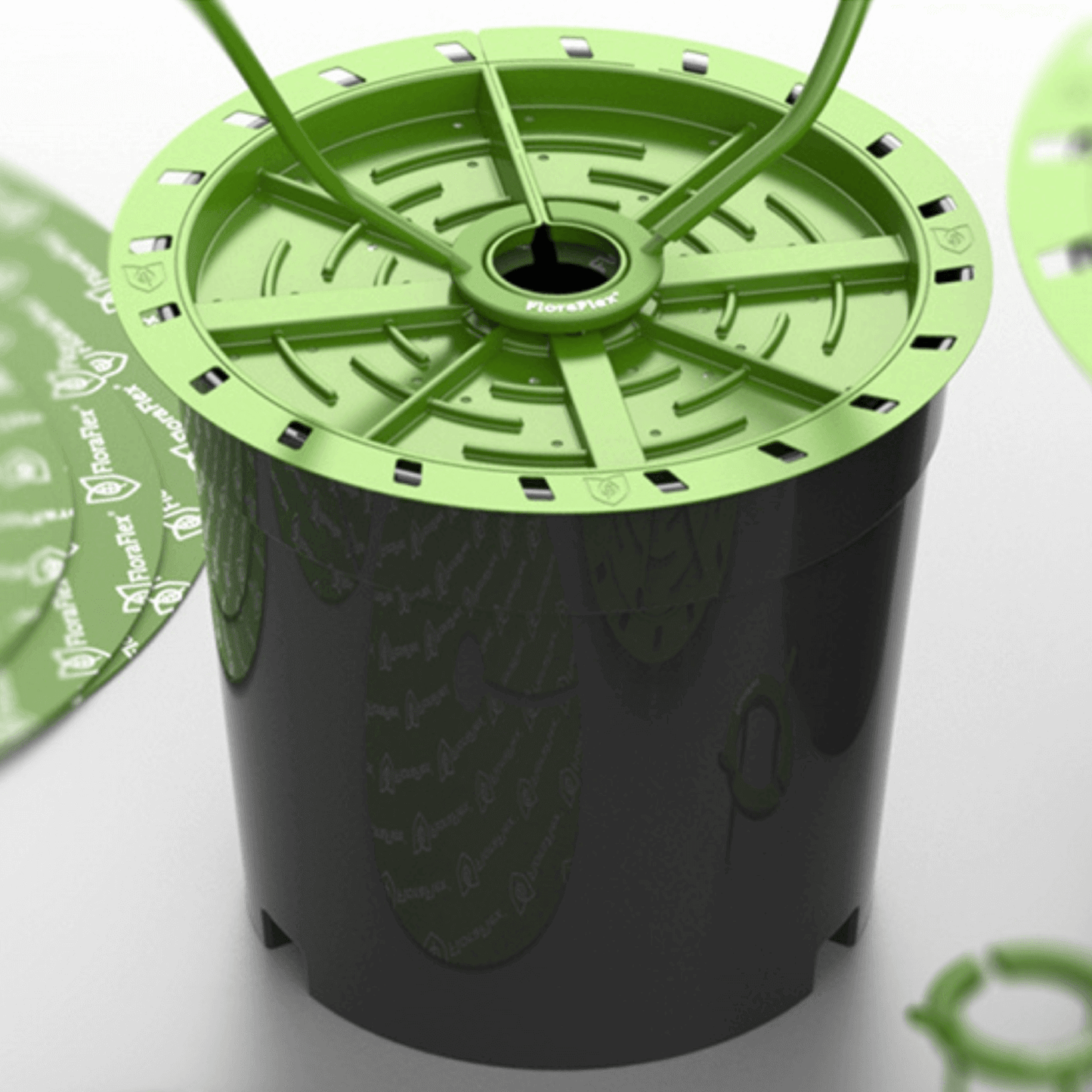 FloraFlex Matrix 10.5" to 12" irrigation disc, 12-pack, shown on a plant pot for optimal watering and growth.