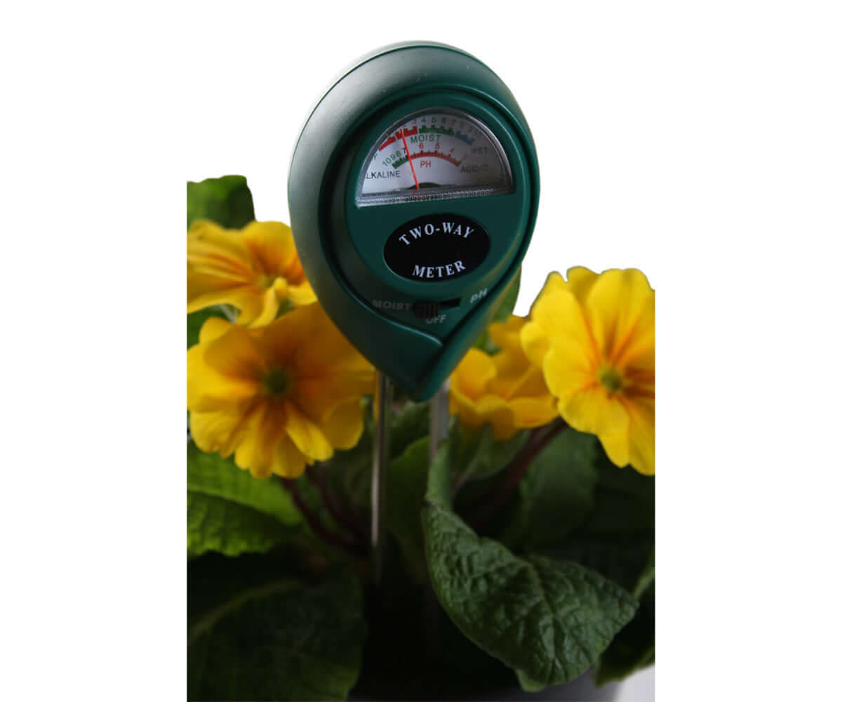 Active Air 2-Way moisture and pH meter displayed among yellow flowers, highlighting its gardening utility.