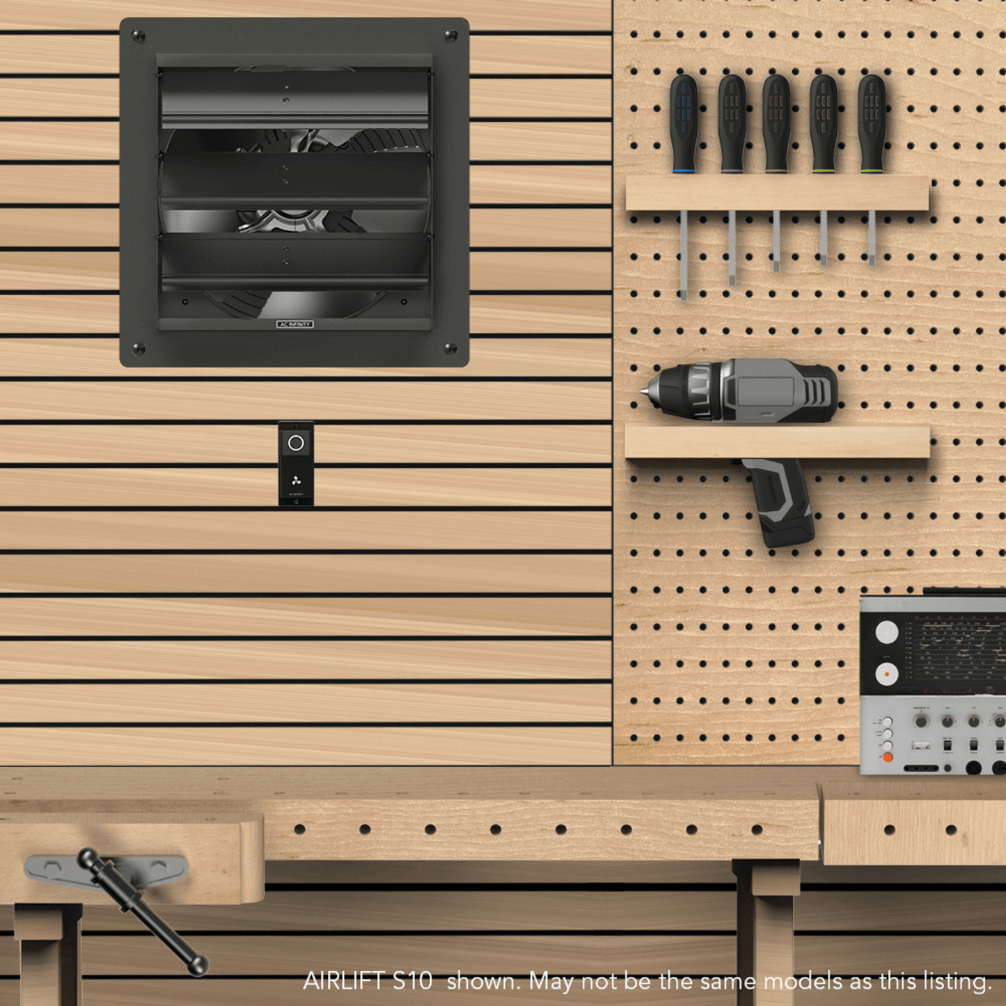 Industrial workshop with AC Infinity AIRLIFT S10 exhaust fan installed on a wooden wall, alongside tools and equipment.